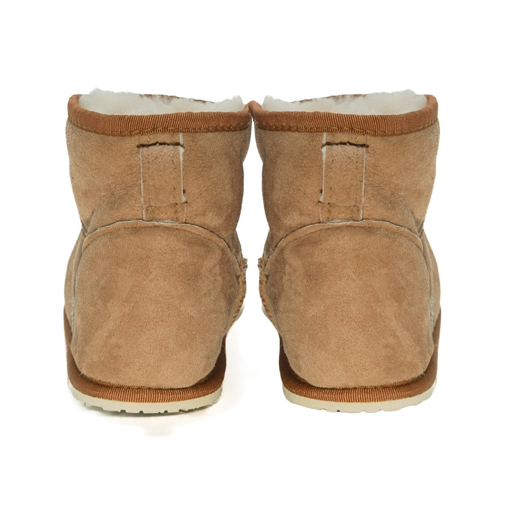 A plain light-brown Zeazoo Dingo Mini sheepskin ankle boot with a back pull tab, cream wool lining, and cream rubber vibram soles. Both shoes are shown from the back against a white background. #color_chestnut