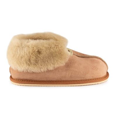 Chestnut colored Zeezoo Dolly hand made suede, sheepskin, and tan rubber slippers. The slippers are composed of 4 panels sewn together with seams on the sides, back, and top. Fur lining folds over at the ankle. Right slipper is shown facing right against a white background. #color_chestnut