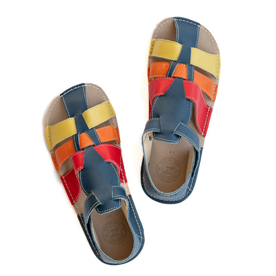A photo of the Zeazoo Marlin lids leather play sandals. The sandals are navy blue in color and have yellow, orange, and red straps weaved across the top of the shoe, and a velcro closure around the ankle. Both shoes are shown together from above on a white background. #color_navy-yellow-orange-red