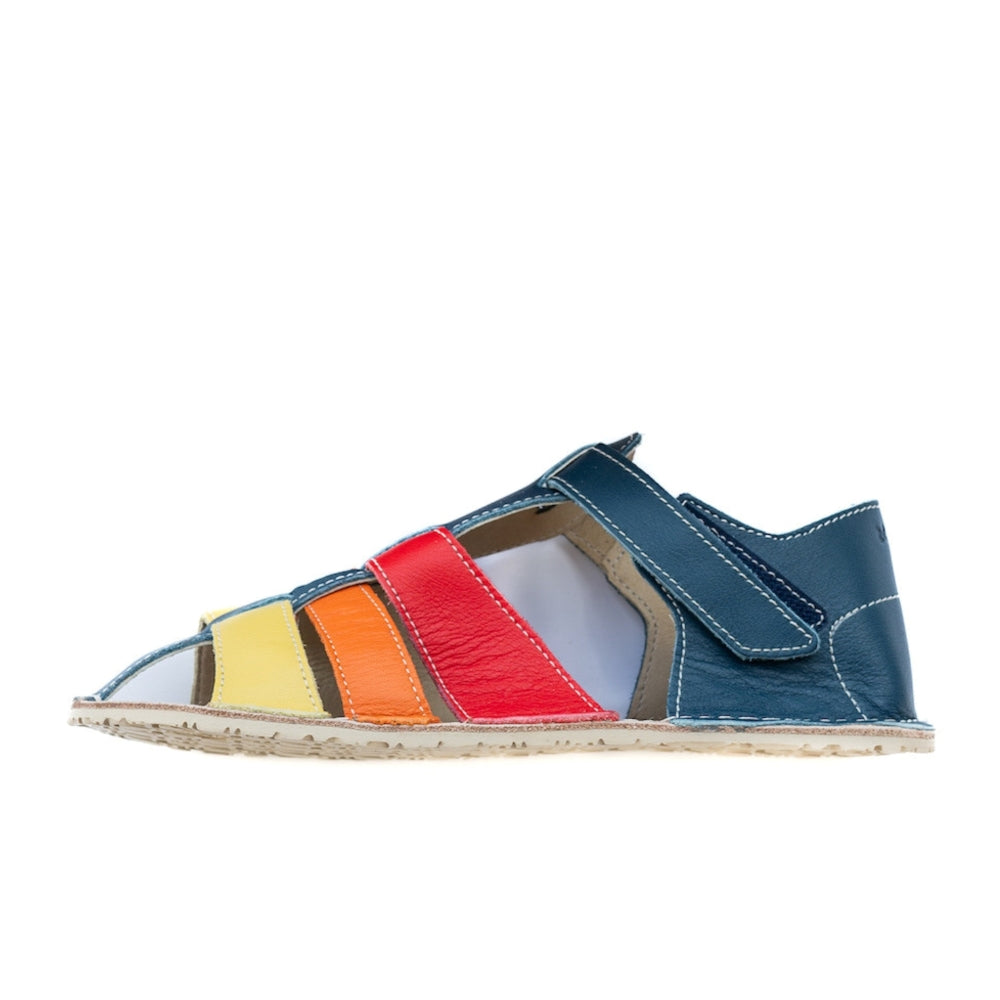 A photo of the Zeazoo Marlin lids leather play sandals. The sandals are navy blue in color and have yellow, orange, and red straps weaved across the top of the shoe, and a velcro closure around the ankle. Left shoe is shown from the side facing left against a white background. #color_navy-yellow-orange-red