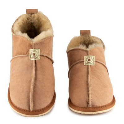 Zeezoo Shaun hand made suede, sheepskin, and tan rubber slippers. The slippers are composed of 4 panels sewn together with seams on the sides, back, and top. Both slippers are shown from the front with the left slipper tilted up against a white background. #color_chestnut