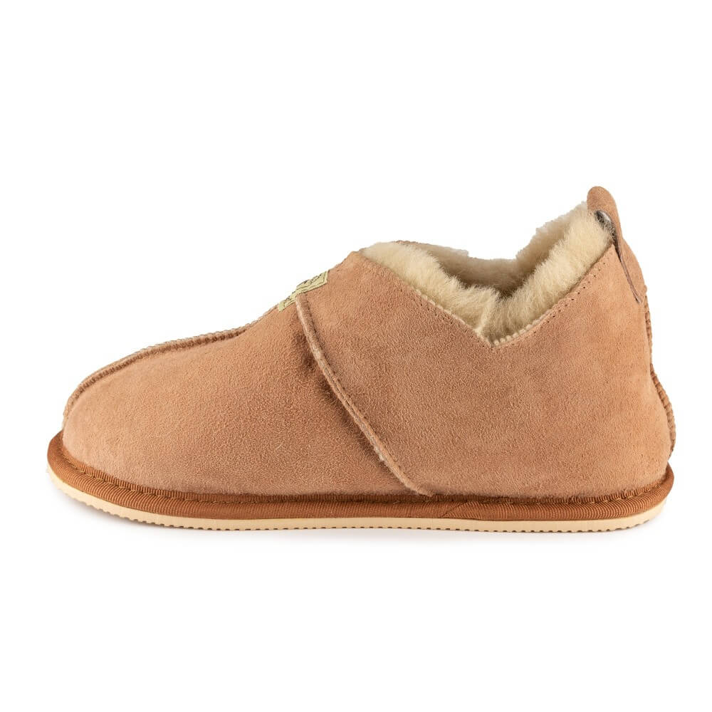 Zeezoo Shaun hand made suede, sheepskin, and tan rubber slippers. The slippers are composed of 4 panels sewn together with seams on the sides, back, and top. Right slipper is shown facing left against a white background. #color_chestnut