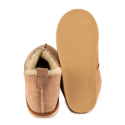 Zeezoo Shaun hand made suede, sheepskin, and tan rubber slippers. The slippers are composed of 4 panels sewn together with seams on the sides, back, and top. Left slipper is shown from the back while the right slipper sole if shown tilted upwards against a white background. #color_chestnut 