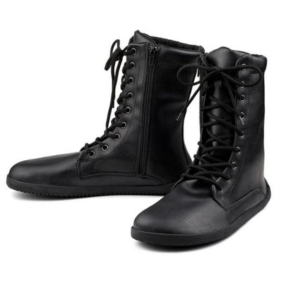 A photo of Ahinsa Jaya boots made from faux leather and rubber soles. The boots are black in color the fit is mid calf and they have laces all the way up. Both boots are shown beside each other slightly spaced out and facing opposite directions against a white background. #color_black