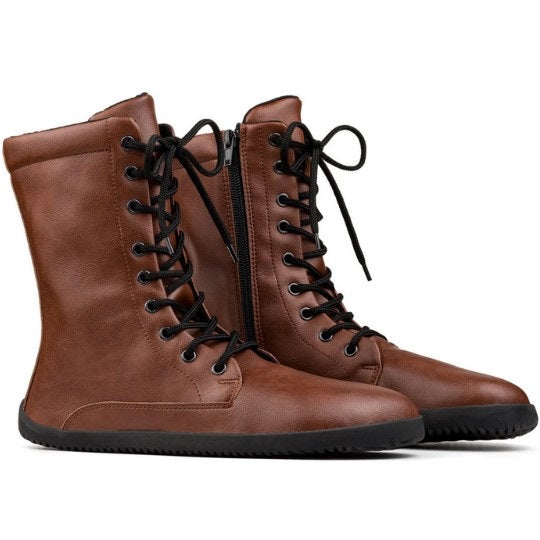 A photo of Ahinsa Jaya boots made from faux leather and rubber soles. The boots are brown in color the fit is mid calf and they have laces all the way up. Both boots are shown beside each other from the right side against a white background. #color_brown