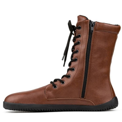 A photo of Ahinsa Jaya boots made from faux leather and rubber soles. The boots are brown in color the fit is mid calf and they have laces all the way up. One boot is shown from the right side against a white background. #color_brown