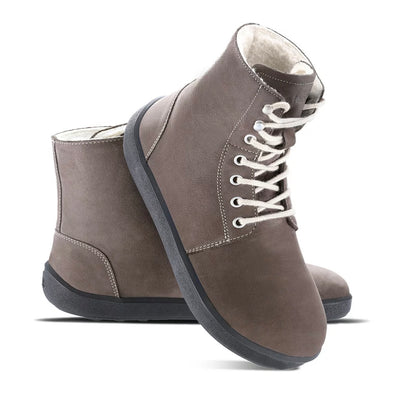 A photo of Be Lenka Winter Neo boots made with nubuck leather and rubber soles. The boots are chocolate brown in color and a lace up style with wool inside. Both boots are shown beside each other from the right side, the right boot’s heel is leaning on against the left boot against a white background. #color_chocolate-brown-nubuck