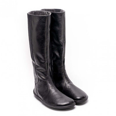 A photo of Belenka Sierra made from smooth leather, fleece, and rubber soles. The boots are black in color with a tall riding boot elastic paneled shaft lined with fleece. Both both are shown beside each other from the right side angled slightly to the front against a white background. #color_black
