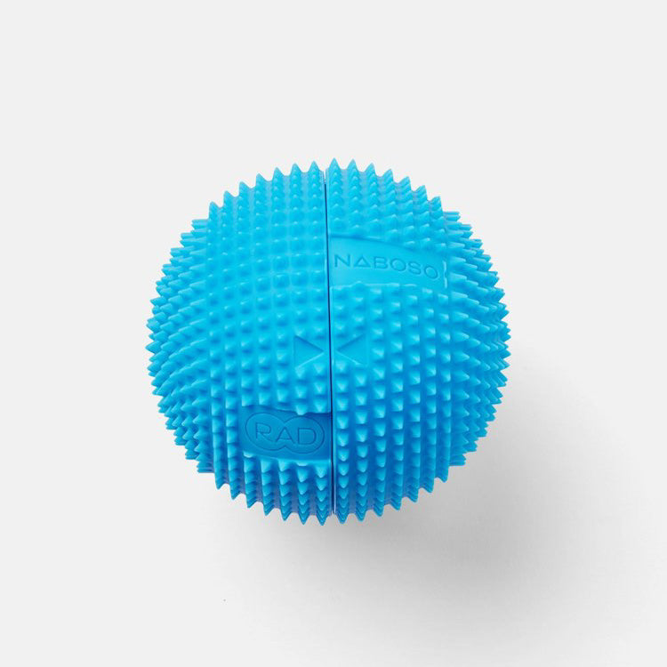 A photo of Naboso neuro ball that can be split in half and contains a smaller RAD ball inside. The blue is blue in color and textured and can be used on the feet. A photo of the textured ball against a white background. 