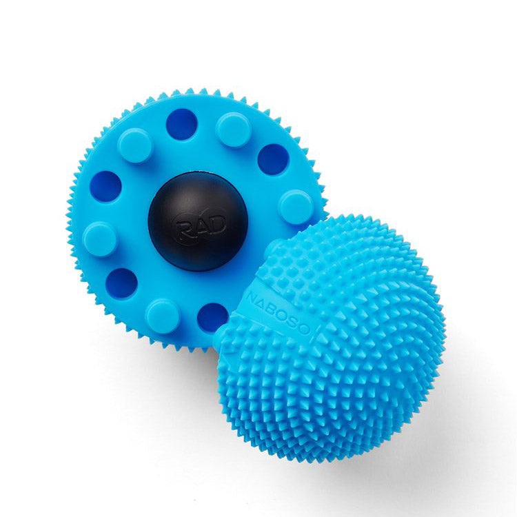 A photo of Naboso neuro ball that can be split in half and contains a smaller RAD ball inside. The ball is blue in color and textured and can be used on the feet. A photo of the ball split to show the smaller ball inside against a white background. 