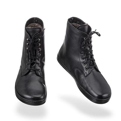 A photo of Peerko Frost combat boots made with smooth leather, wool, and rubber soles. The boots are black in color, wool lined, with silver speed hooks at the top. Both boots are shown floating forward angled slightly to the right against a white background. #color_black