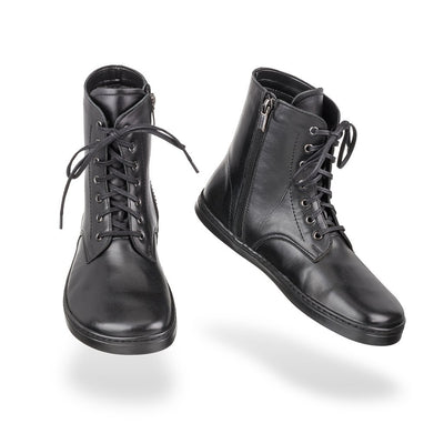 A photo of Peerko Go combat boots made with smooth leather, fleece, and rubber soles. The boots are black in color, fleece lined, with a zipper at the side. Both boots are shown floating forward angled slightly to the right against a white background. #color_black
