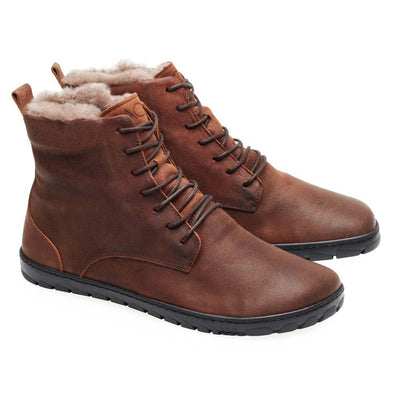 A photo of Zaqq Quintic boots made nappa leather, wool, and rubber soles. The boots are brown in color with dark brown laces and a wool lining inside. Both boots are shown beside each other facing left against a white background. #color_brown