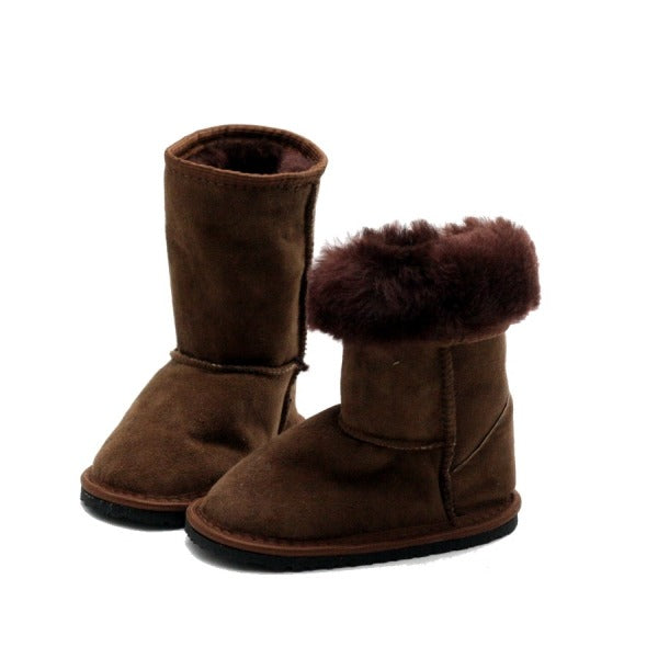 A photo of kids Zeezoo dingo boots made with suede lined with sheepskin and rubber soles. The boots are brown in color and they go around the mid calf. Both boots are shown beside each other angled towards the right the left boot has the top folded down the show the fuzzy inside against a white background. #color_brown