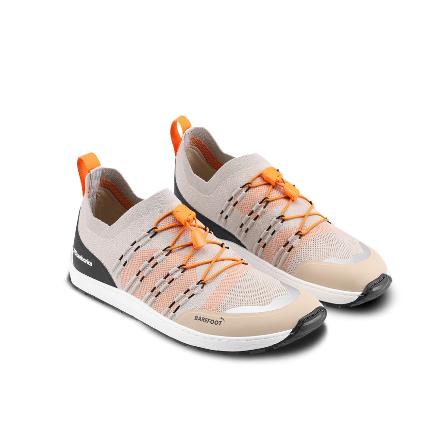 Photo 1 - A photo of Barebarics Voyager active sneakers. The sneakers are made with a beige sock-like stretch fabric with black protector fabric around the front and back of the shoe. Interwoven black strings on either side hold the orange elastic quick laces in place. Right sneaker is shown here from the right side against a white background., Photo 2 - Both shoes are shown from the top down against a white background. #color_beight-white