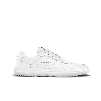 A photo of Barebarics Zing sneakers made with a leather upper and a rubber sole. The sneakers are a white color with perforated spots on the top of the toe box and barebarics branding on the tongue and side. The left sneaker is shown from the side against a white background. #color_white