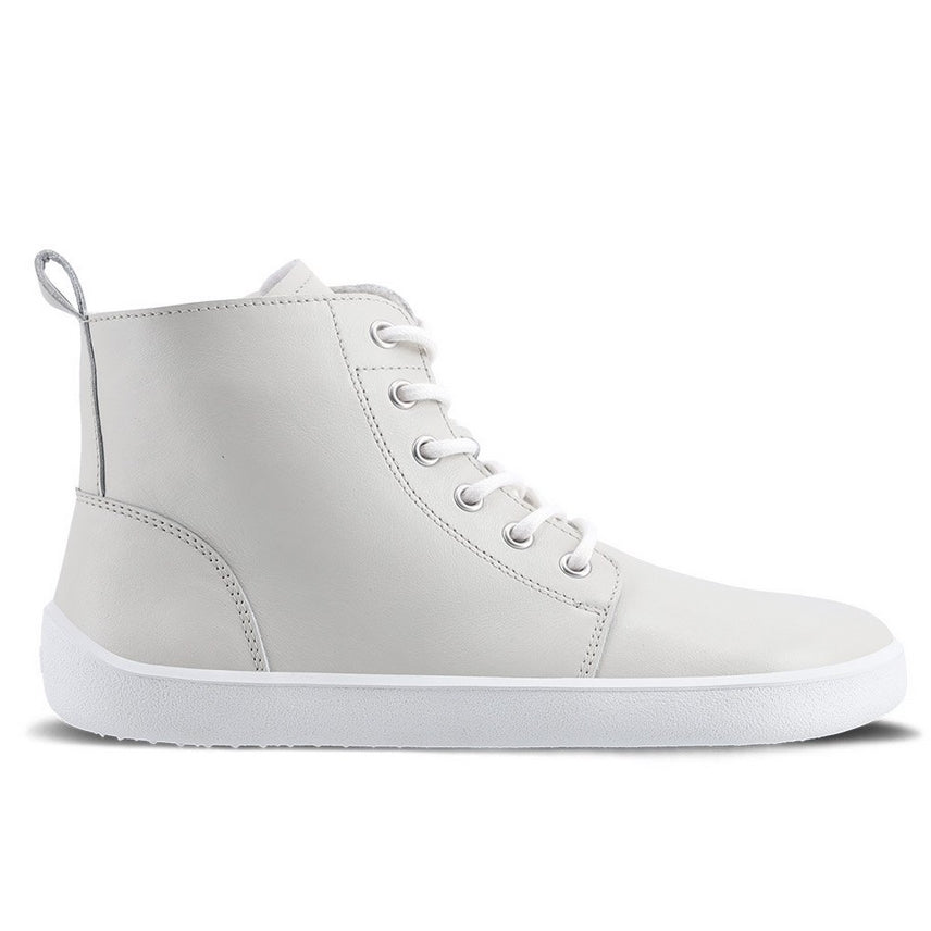 A photo of Be Lenka Atlas ankle zip up boots made from smooth leather and rubber soles. The boots are cream color with white laces, zippers, a pull tab in the back, and lined with felt. The right boot is shown from the right side against a white background. #color_cream