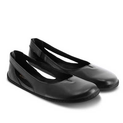 A photo of Be Lenka Bellissima flats with a leather upper and rubber soles. The flats are a black color with a small stitching V detail in the front and a cut out design on the sides. Both shoes are shown beside each other from the right side angled to the front against a white background in this photo. #color_black