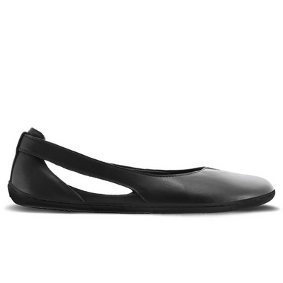 A photo of Be Lenka Bellissima flats with a leather upper and rubber soles. The flats are a black color with a small stitching V detail in the front and a cut out design on the sides. The left shoe is shown from the right side against a white background in this photo. #color_black