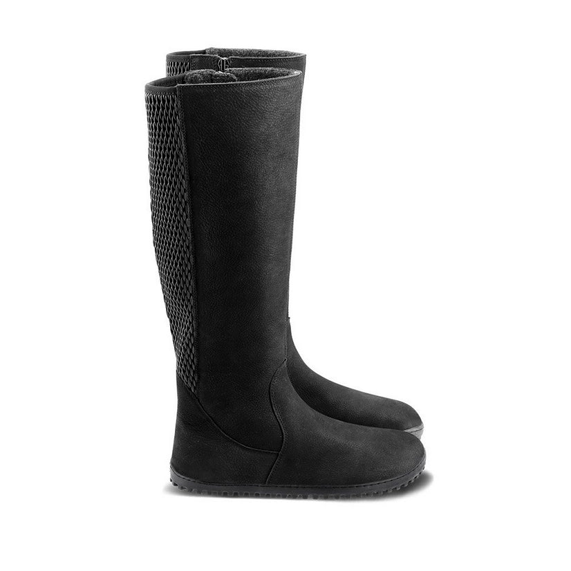 A photo of Belenka Charlotte riding boots made from suede leather, fleece lining, and rubber soles. The boots are black in color with an elastic paneled shaft around the back. Both boots are shown beside each other from the right side against a white background. #color_matte-black