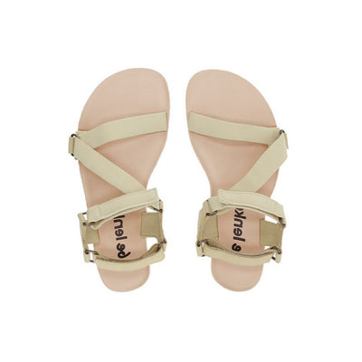 A photo of Beige Green Be Lenka Flexi Sandals made with fabric straps with velcro and a tan leather topped rubber soles. The sandals are a light beige green color and have straps that cross the front of the foot and continue around the mid-foot, ankle, and heel. Both sandals are shown from the top down beside each other against a white background in this photo. #color_beige-green