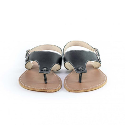 A photo of Black Be Lenka Promenade Sandals made with leather and tan rubber soles. The sandals have black thong straps and a heel strap with a buckle. Both sandals are shown from the front beside each other against a white background in this photo. #color_black