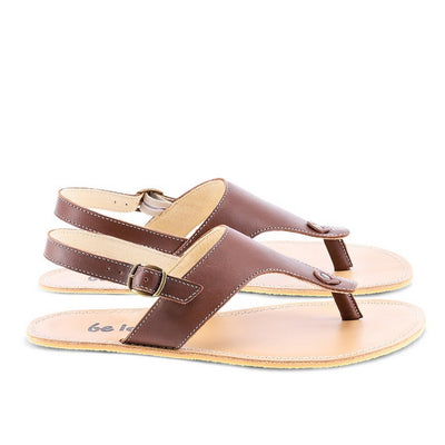 A photo of Dark Brown Be Lenka Promenade Sandals made with leather and tan rubber soles. The sandals have dark brown thong straps and a heel strap with a buckle. Both sandals are shown from the right side against a white background in this photo. #color_dark-brown