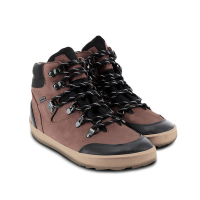 A photo of Be Lenka Ranger boots made with oiled nubuck leather, fleece, and rubber soles. The boots are a hiking boot style and are brown in color with black trim and a fleece lining. Both boots are shown beside each other angled slightly to the right side against a white background. #color_dark-brown