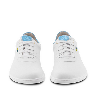 A photo of Be Lenka Royale sneakers made with a leather upper and a rubber sole. The sneakers are a white color and the area around the heel is light blue, they have small yellow and blue tag on the side. Both shoes are shown beside each other from the front against a white background. #color_white-blue