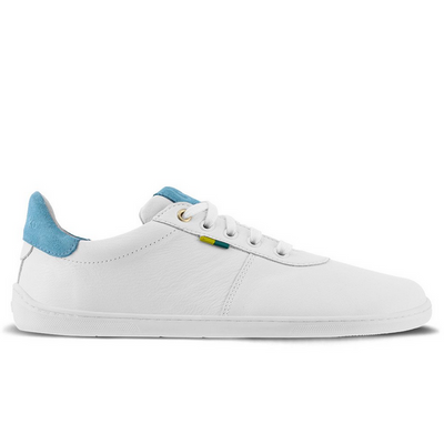 A photo of Be Lenka Royale sneakers made with a leather upper and a rubber sole. The sneakers are a white color and the area around the heel is light blue, they have small yellow and blue tag on the side. The right sneaker is shown from the side against a white background. #color_white-blue