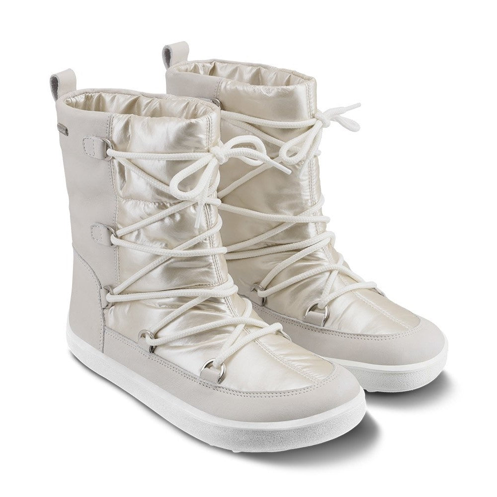 A photo of Be Lenka Adult Snowfox boots in Pearl White. Pearl white leather goes around the back with pearly white satin over the top and front, and white soles. Laces are widely connected from side to side starting at the ball of the foot and going until the top of the boot. Both shoes are shown diagonally from the front right against a white background. #color_pearl-white