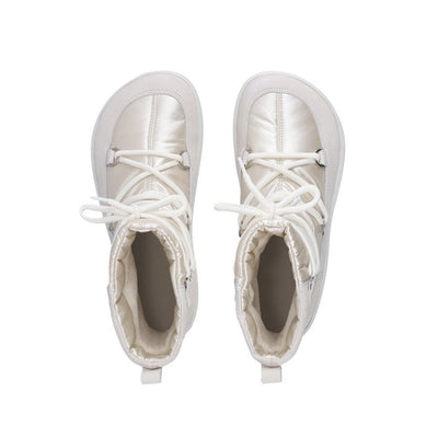 A photo of Be Lenka Adult Snowfox boots in Pearl White. Pearl white leather goes around the back with pearly white satin over the top and front, and white soles. Laces are widely connected from side to side starting at the ball of the foot and going until the top of the boot. Both boots are shown from the top down against a white background. #color_pearl-white