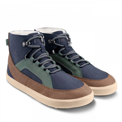 A photo of Be Lenka York ankle lace up boots made from nubuck leather and tan rubber soles. The boots have a navy base color with brown wrapped around the edge of the shoe up the back of the ankle, green angled arch detailing on either side of the laces, and grey laces. Both boots are shown diagonally from the front right against a white background. #color_navy-brown-beige