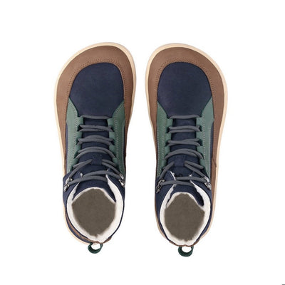 A photo of Be Lenka York ankle lace up boots made from nubuck leather and tan rubber soles. The boots have a navy base color with brown wrapped around the edge of the shoe up the back of the ankle, green angled arch detailing on either side of the laces, and grey laces. Both boots are shown from the top down against a white background. #color_navy-brown-beige