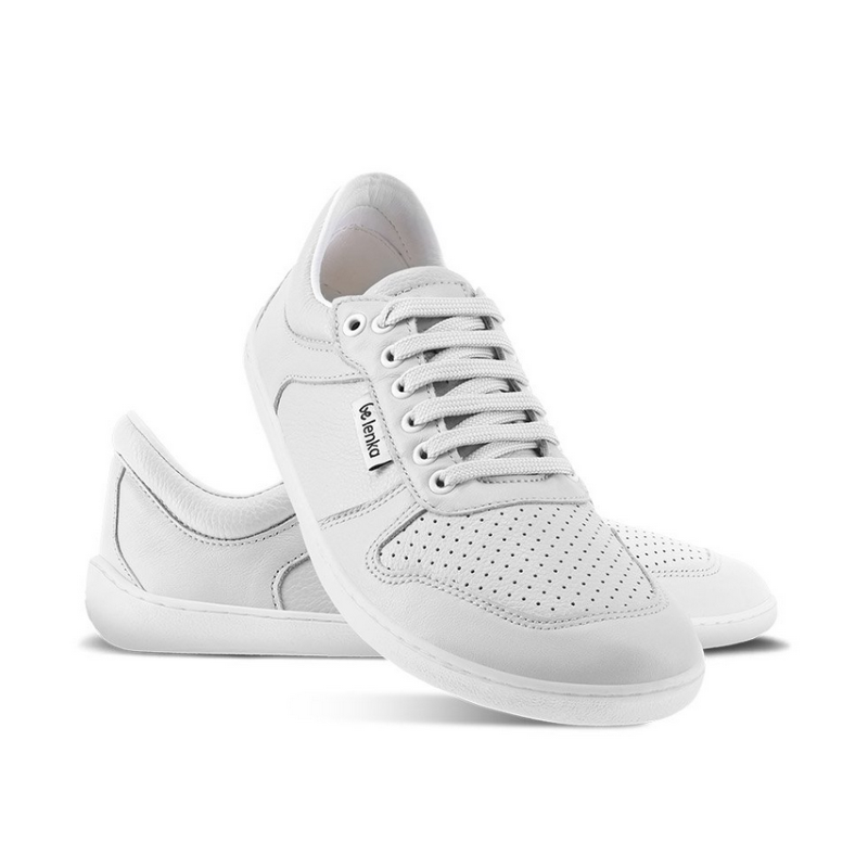 A photo of Belenka Champ sneakers made from leather and rubber soles. The sneakers are white in color with perforation on the toe box and detail stitching. The right shoes heel is leaning up against the left shoe showing the right shoe from the front facing down shown against a white background. #color_white