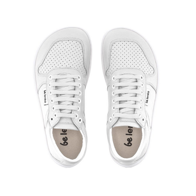 A photo of Belenka Champ sneakers made from leather and rubber soles. The sneakers are white in color with perforation on the toe box and detail stitching. Both sneakers are shown facing upright beside each other from the top down against a white background. #color_white