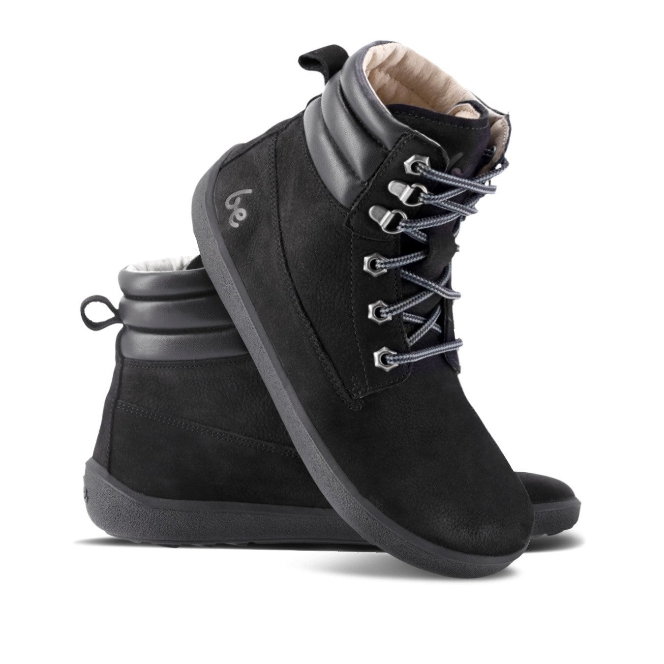 A photo of Be Lenka Nevada Boots made from nubuck leather and rubber soles. The boots are black in color, they are combat boot style with laces, a padded collar and a chunky eyelets. Both boots are shown beside each other from the right side, the right boot’s heel is leaning on against the left boot against a white background. #color_black