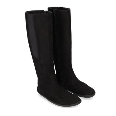 A photo of Belenka Sierra made from nubuck leather, fleece, and rubber soles. The boots are black in color with a tall riding boot elastic paneled shaft lined with fleece. Both boots are shown beside each other from the right side angled slightly to the front against a white background. #color_matt-black