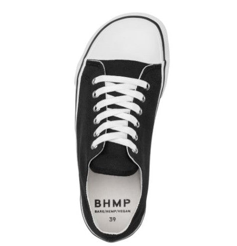 A photo of Bohempia Herlik canvas sneakers made from canvas and rubber soles. The sneakers are a black color with a white toe cap and a black outline around the white rubber soles. The left sneaker is shown from above on a white background. #color_black-white