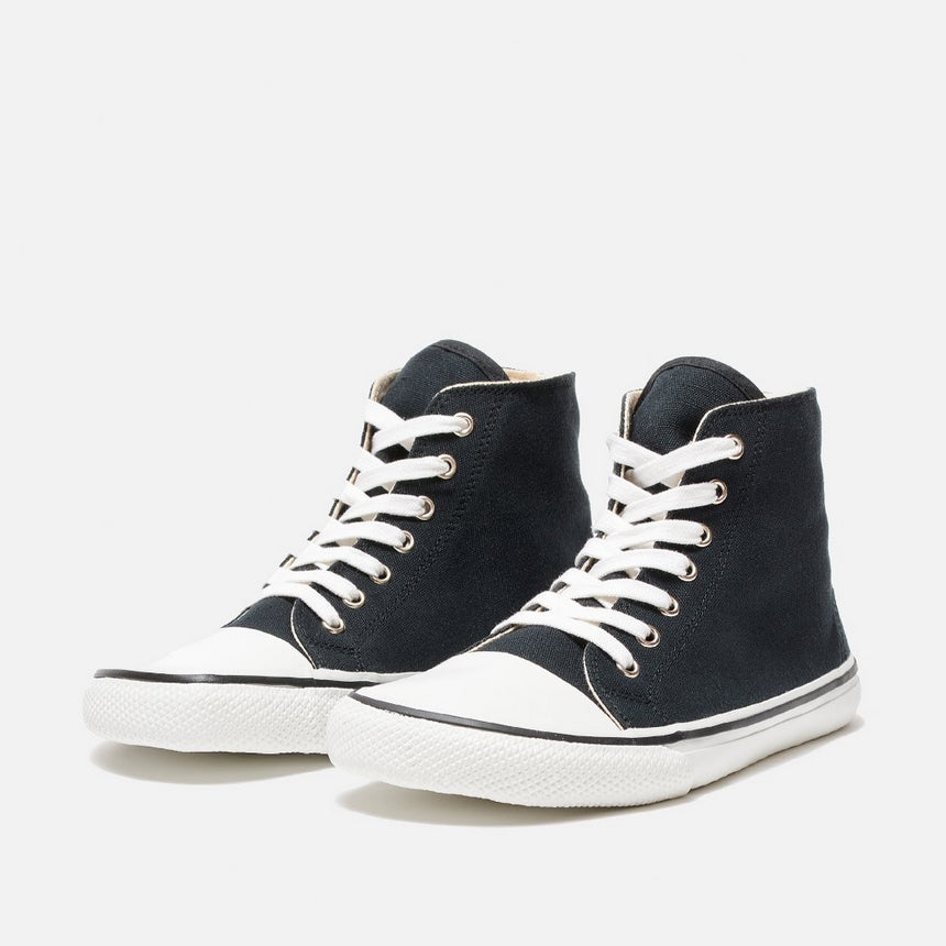 A photo of Bohempia Orik canvas high tops made from canvas and rubber soles. The sneakers are a black color with a white toe cap and a black outline around the rubber. Both sneakers are shown beside each other  angled to the right side against a white background. #color_black-white