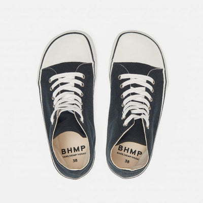 A photo of Bohempia Orik canvas high tops made from canvas and rubber soles. The sneakers are a black color with a white toe cap and a black outline around the rubber. Both sneakers are shown from above against a white background. #color_black-white