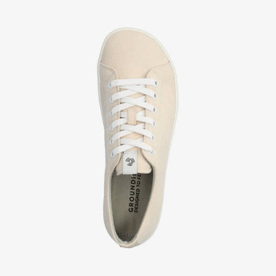 A photo of Groundies Brooklyn Low Canvas Sneakers. The sneakers are made with cream colored canvas, white laces, and white soles. Both shoes are shown diagonally from the left side against a white background in this photo. #color_beige, A photo of Groundies Brooklyn Low Canvas Sneakers. The sneakers are made with cream colored canvas, white laces, and white soles. Right shoe shown from the top down against a white background in this photo. #color_beige
