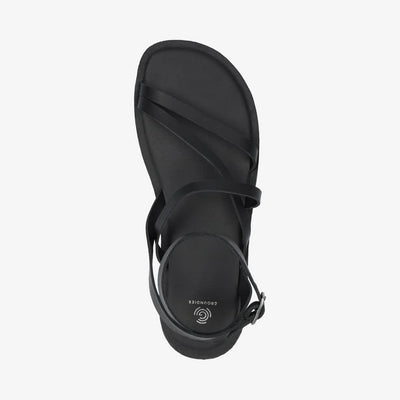 A photo of black leather Groundies Florence Sandals. Two leather straps start at the ball of the big toe with one ending at the ball of the little toe and the other midfoot. Another strap goes from one side of the heel over the top of the foot to the other side with one final strap wrapping around the ankle and closing with a buckle. Right shoe is shown from the top down against a white background. #color_black