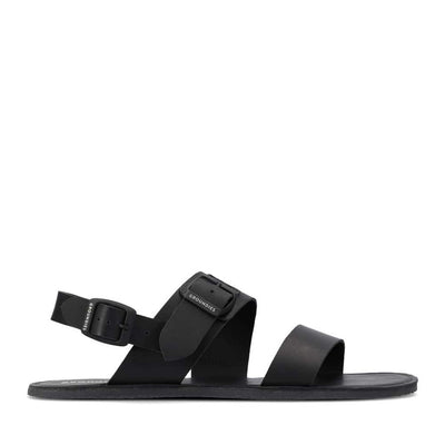 A photo of black leather Groundies Kos Sandals with black rubber soles. One thick strap spans across the base of the toes. Another thick strap goes accross the arch of the foot with a big, black buckle closure. A thinner slingback strap keeps the sandals secure to the foot also with a buckle closure. Right shoe is shown facing right against a white background. #color_black