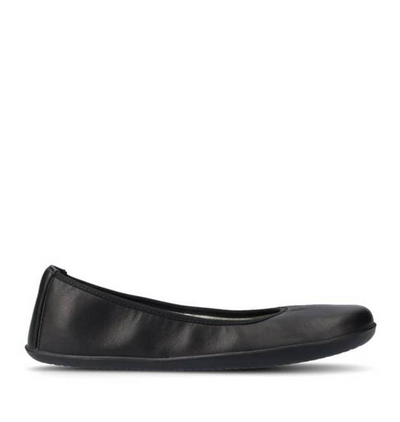 A photo of Groundies Lily Classic flats with a leather upper and black rubber true sense soles. The flats are a smooth leather in a black color with trim around the tops. The interior of the flats is a light beige color. The left flat is shown from the right side against a white background. #color_black