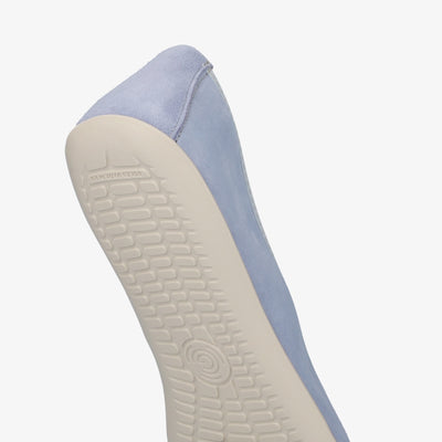 A photo of Groundies Lily Soft flats with a leather upper and cream rubber true sense soles. The flats are a nubuck in a light blue color, the trim around the tops of the flats is a baby blue color and is lighter than the rest of the flats. The interior of the flats is a light beige color. The right flat is shown with a close up of the soles back heel facing downward against a white background. #color_light-blue