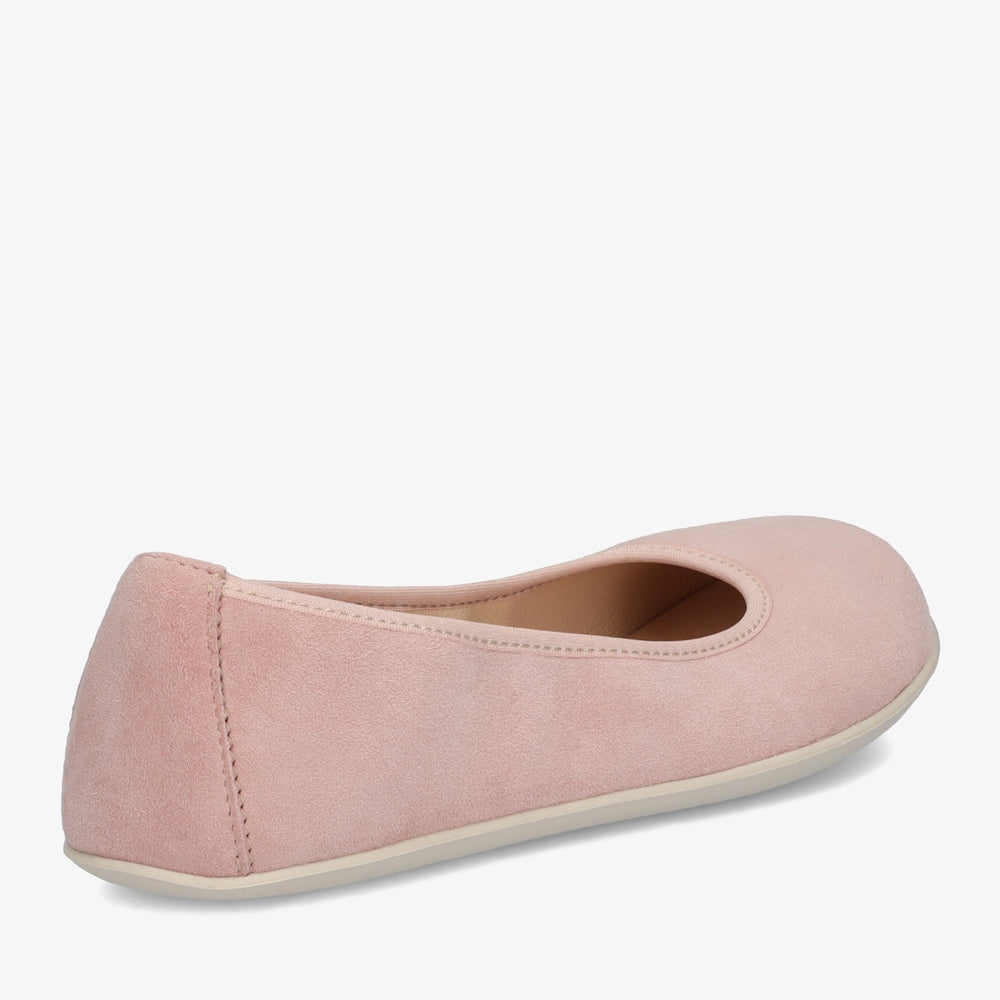 A photo of Groundies Lily Soft flats with a leather upper and cream rubber true sense soles. The flats are a nubuck in a light pink color, the trim around the tops of the flats is a light pink color that is lighter than the rest of the flats. The interior of the flats is a light beige color. The right flat is shown from the back angled to the right side against a white background. #color_light-pink