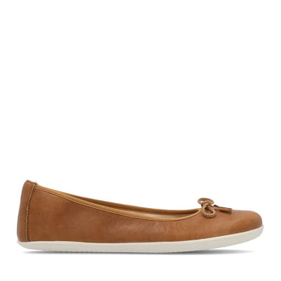 A photo of light brown leather Groundies Magnolia Flats. These classic ballet flats are simple with a leather bow located at the top of the shoe opening. Shoe is shown from the right side against a white background. #color_light-brown