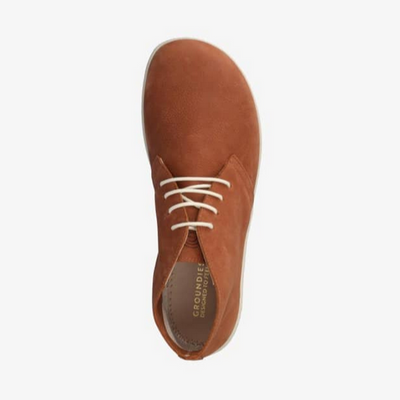 A photo of Groundies Milano an ankle high lace up made from a nubuck leather and a rubber sole. The ankle high lace ups are a cognac color with white GO1 soles and white laces. The right shoe is shown from above facing towards the top against a white background. #color_congac