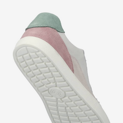A photo of Groundies Nova sneakers made from leather and rubber soles. The sneakers are beige and white with pink/green accents on the heel, they also have perforation on the toe box. The right sneaker is shown up close from the sole against a white background.  #color_beige-green-pink